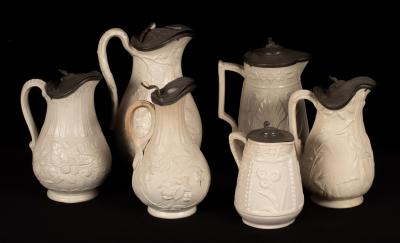 Six saltware jugs, floral