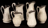 Six saltware jugs, various pat