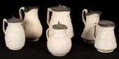Six saltware jugs, various pat