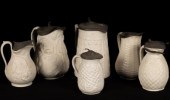 Six saltware jugs, various pat