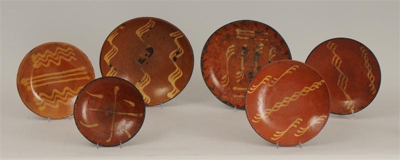 SIX SLIP-DECORATED REDWARE PLATES