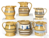 SIX YELLOWWARE PITCHERS, 19TH