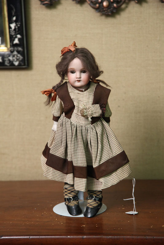 SMALL BISQUE HEAD DOLL. Brown
