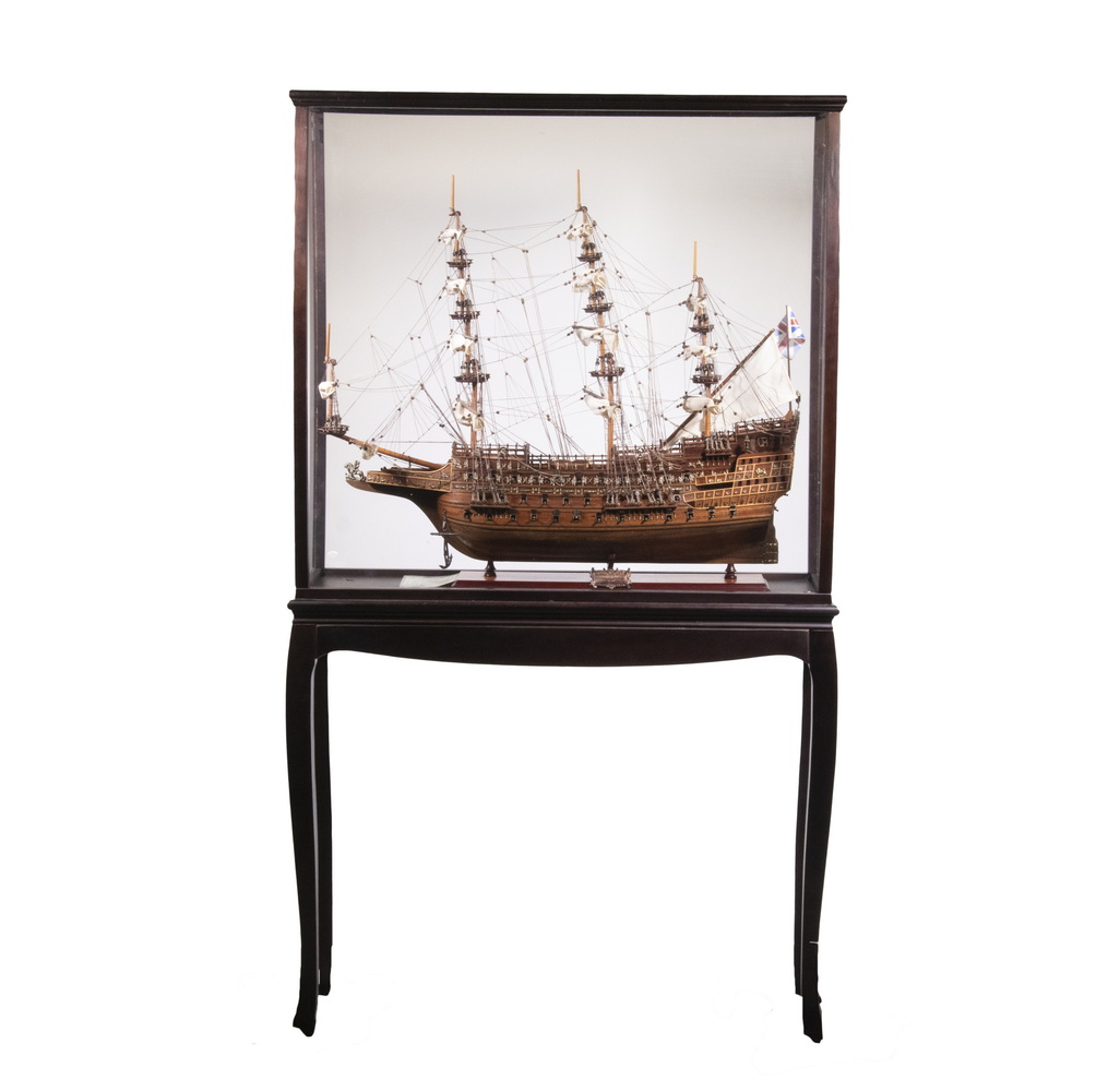 SMALL CASED MODEL OF A SHIP ON