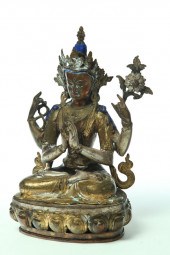 STATUE OF A FOUR-ARMED DEITY.