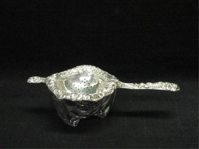 Sterling Tea Strainer on Glass