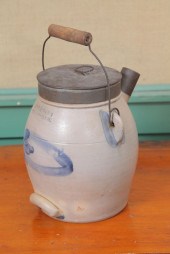 STONEWARE BATTER JUG. With tin
