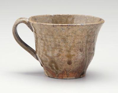 Stoneware cup, strap handle,