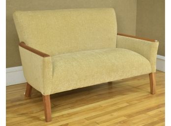 Tan ipholstered settee by