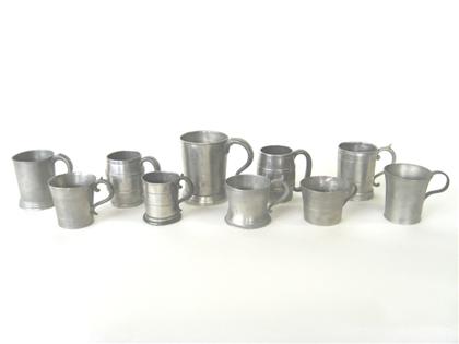 Ten pewter handled beakers   