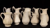 Ten saltware jugs, most with f