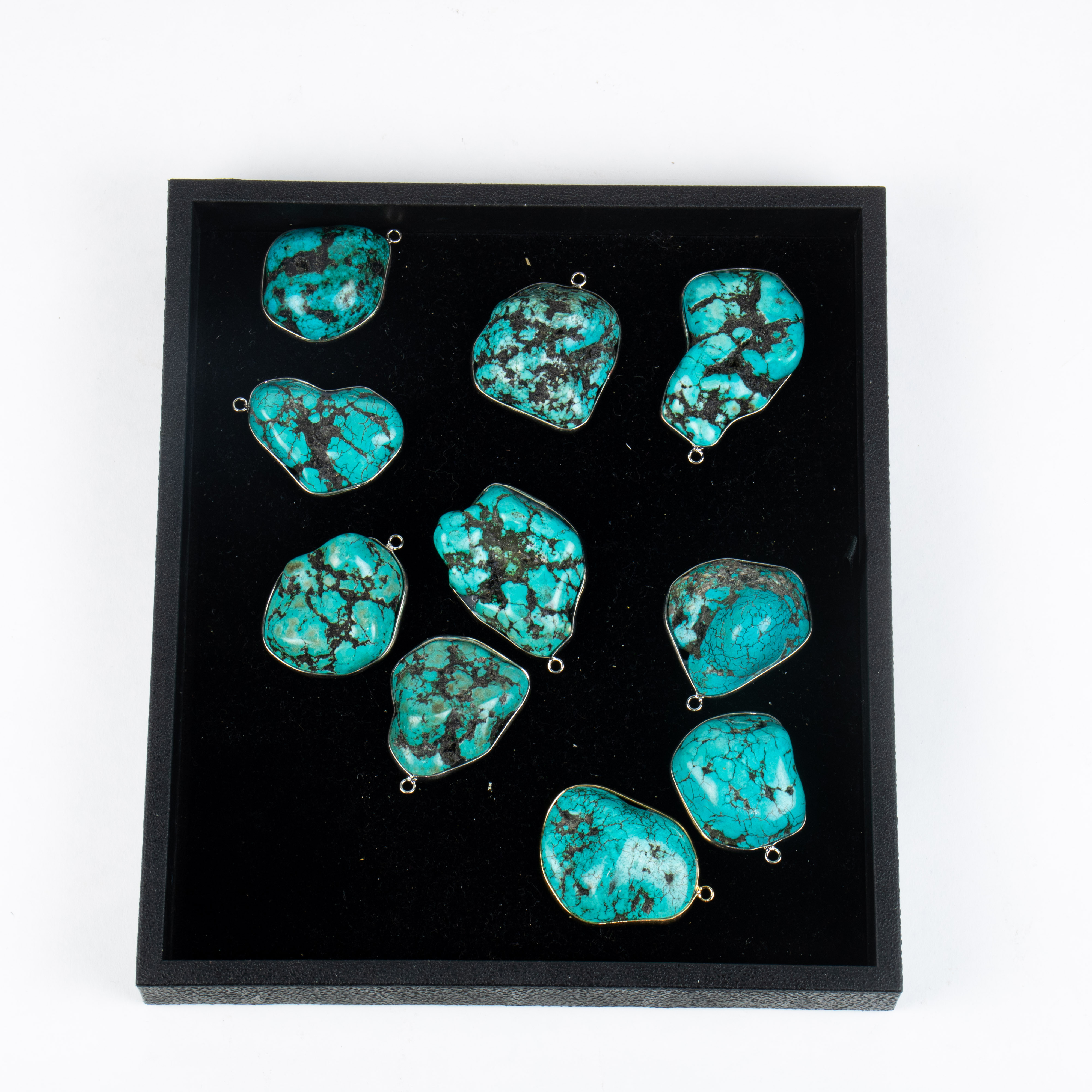 TEN TURQUOISE STONES MOUNTED AS
