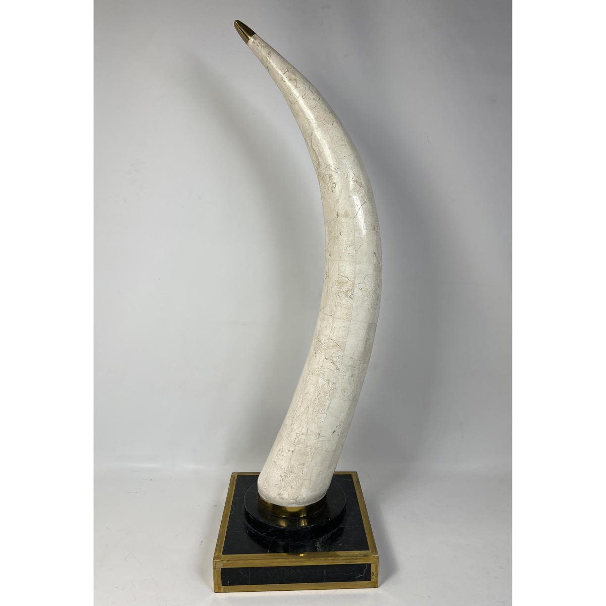 Tessellated stone tusk with brass