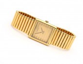 The gold-tone dial marked in b