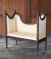 This antique walnut settee is