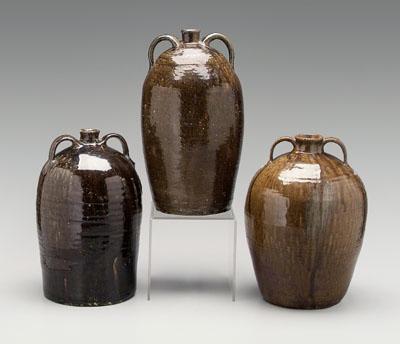 Three alkaline glaze jugs: one with