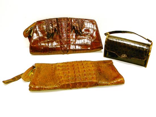 Three alligator purses: one rounded