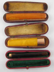 Three amber cigar holders all in