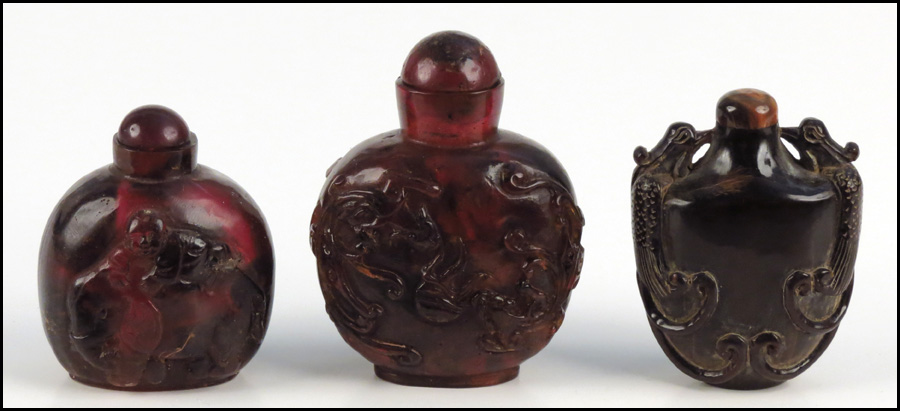 THREE AMBER SNUFF BOTTLES.
