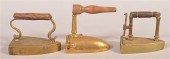 THREE ANTIQUE BRASS SLUG IRONS