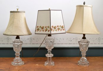 Three antique clear glass oil lamps
