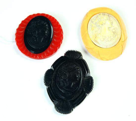 THREE BAKELITE CAMEO PINS. 