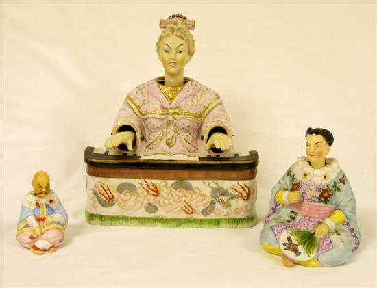 Three bisque porcelain nodder