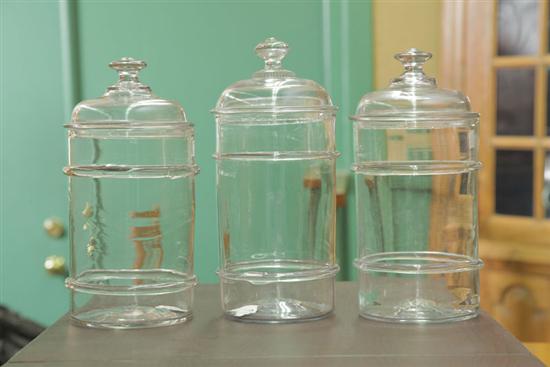 THREE BLOWN GLASS CANISTERS.