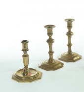 THREE BRASS CANDLESTICKS.  Eur