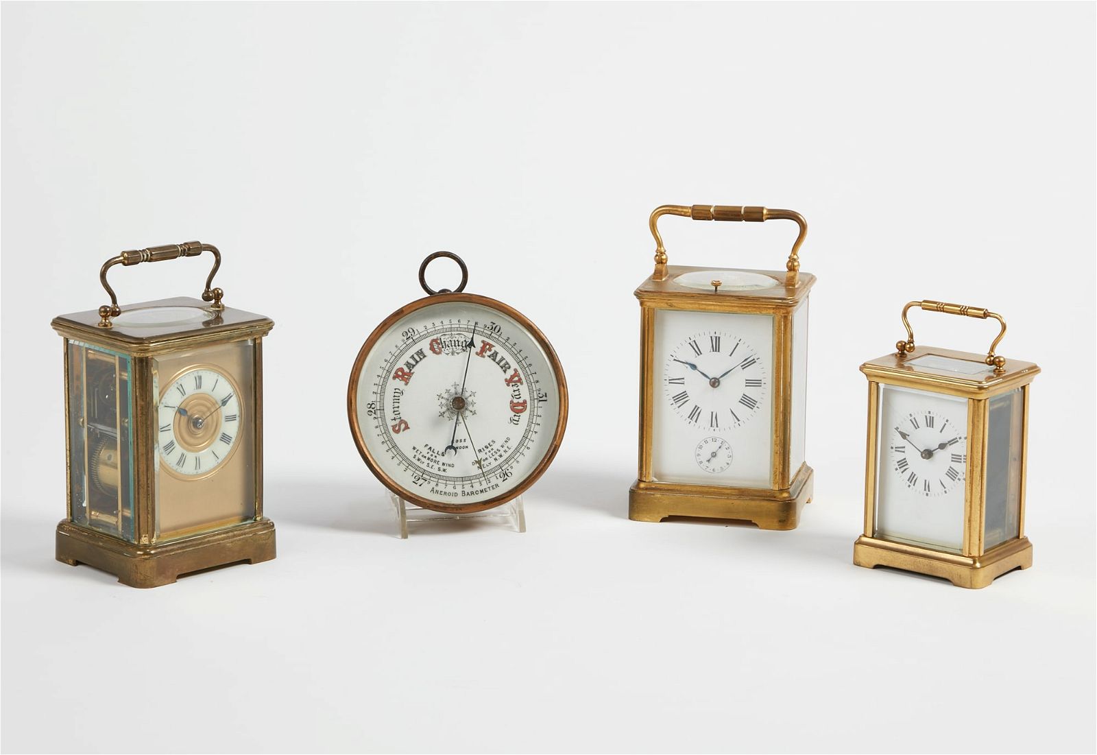 THREE BRASS CARRIAGE CLOCKS AND A