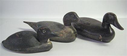 Three carved and painted