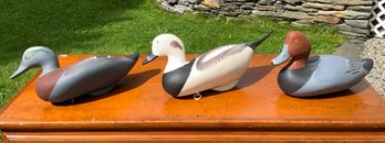 Three carved and painted signed