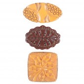 THREE CARVED BAKELITE PINS 2"H