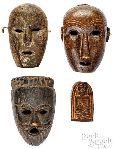 THREE CARVED NEPALESE MASKSThree