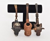 Three carved smoking pipes, Al