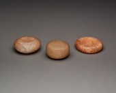 THREE CARVED STONE DISCOIDALST