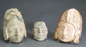 THREE CARVED STONE MASKSThree