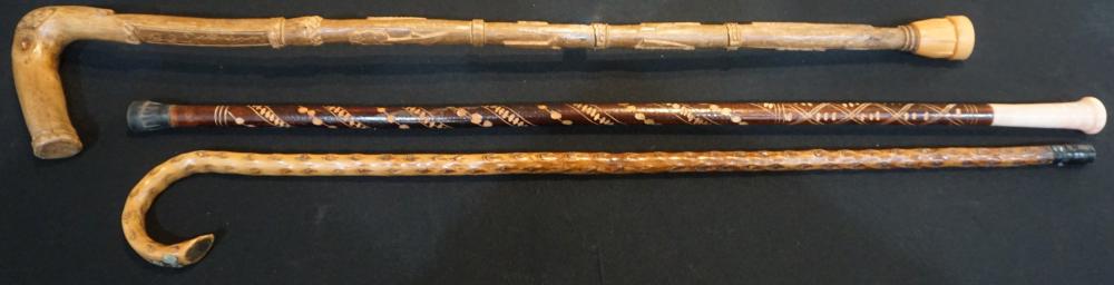 THREE CARVED WOOD CANESThree Carved