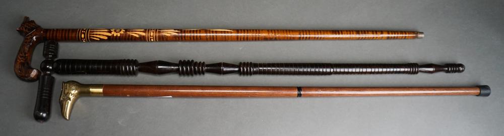 THREE CARVED WOOD WALKING