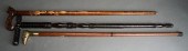 THREE CARVED WOOD WALKING STIC