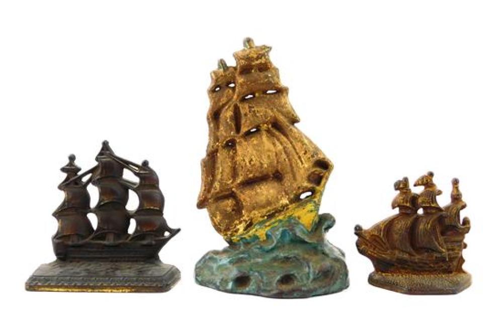 THREE CAST IRON DOORSTOPS OF