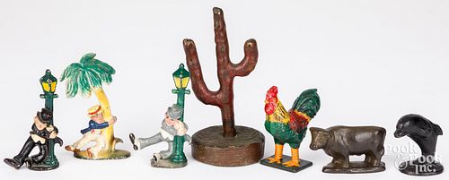 THREE CAST IRON DRUNK BOTTLE