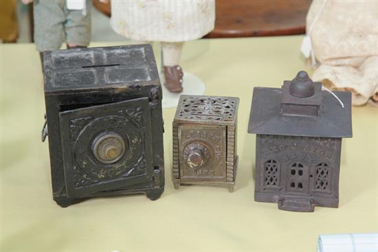 THREE CAST IRON PENNY BANKS.