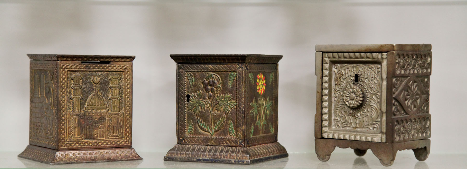 THREE CAST IRON STILL BANKS. 