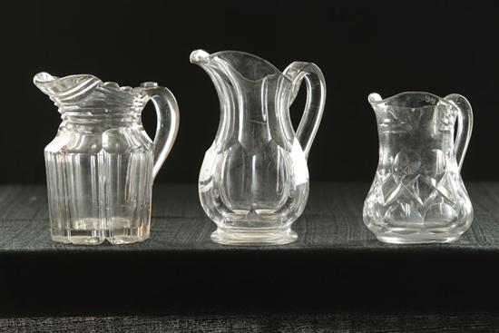 THREE CLEAR CUT MILK PITCHERS. 
