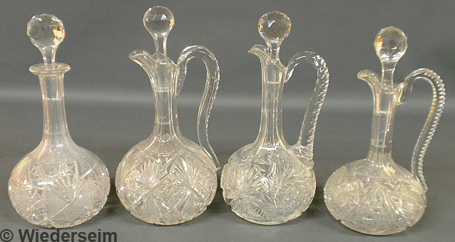 Three cut glass wine ewers and a