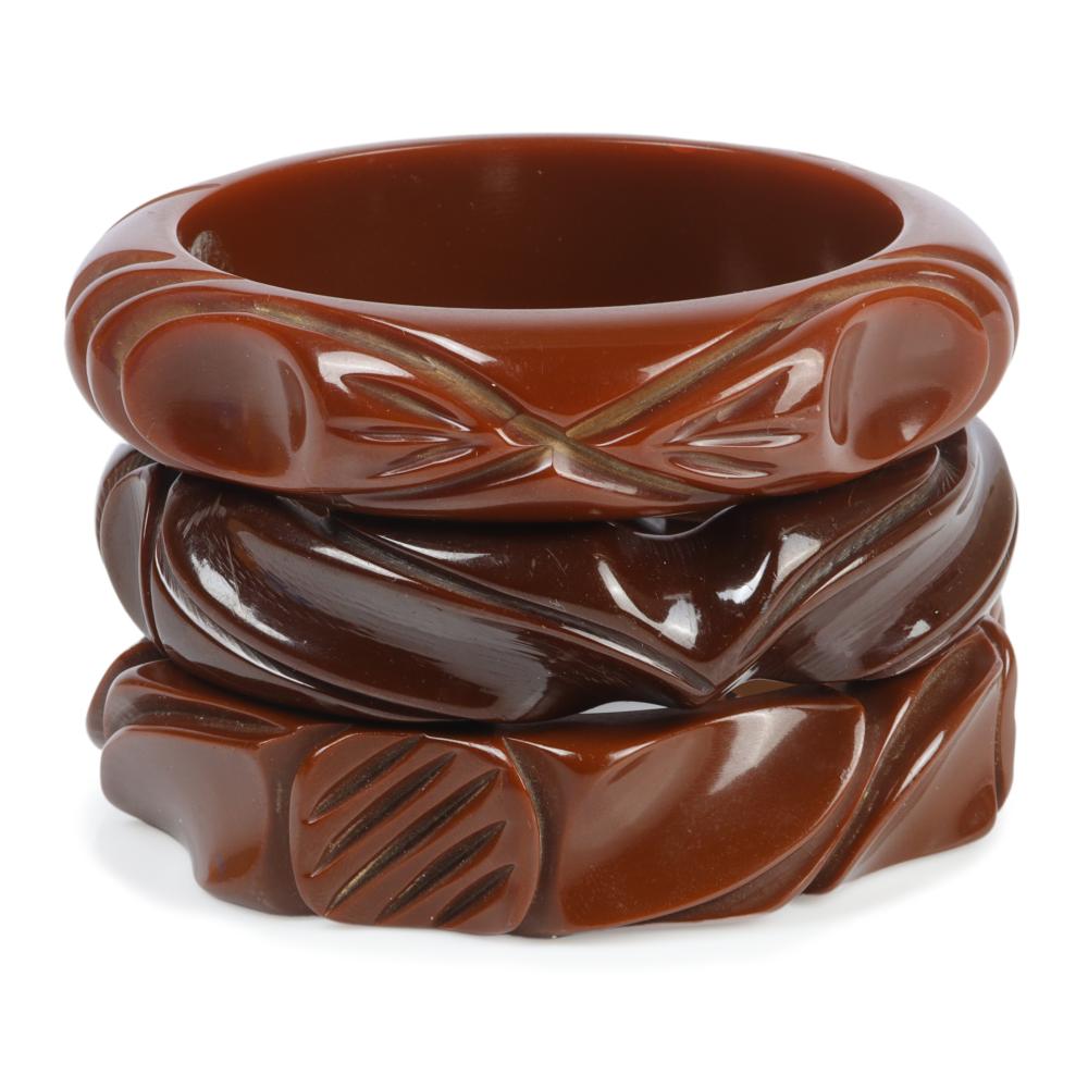 THREE DEEPLY CARVED BAKELITE BANGLE
