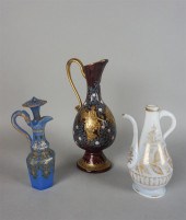 THREE ENAMELED GLASS EWERSTHRE