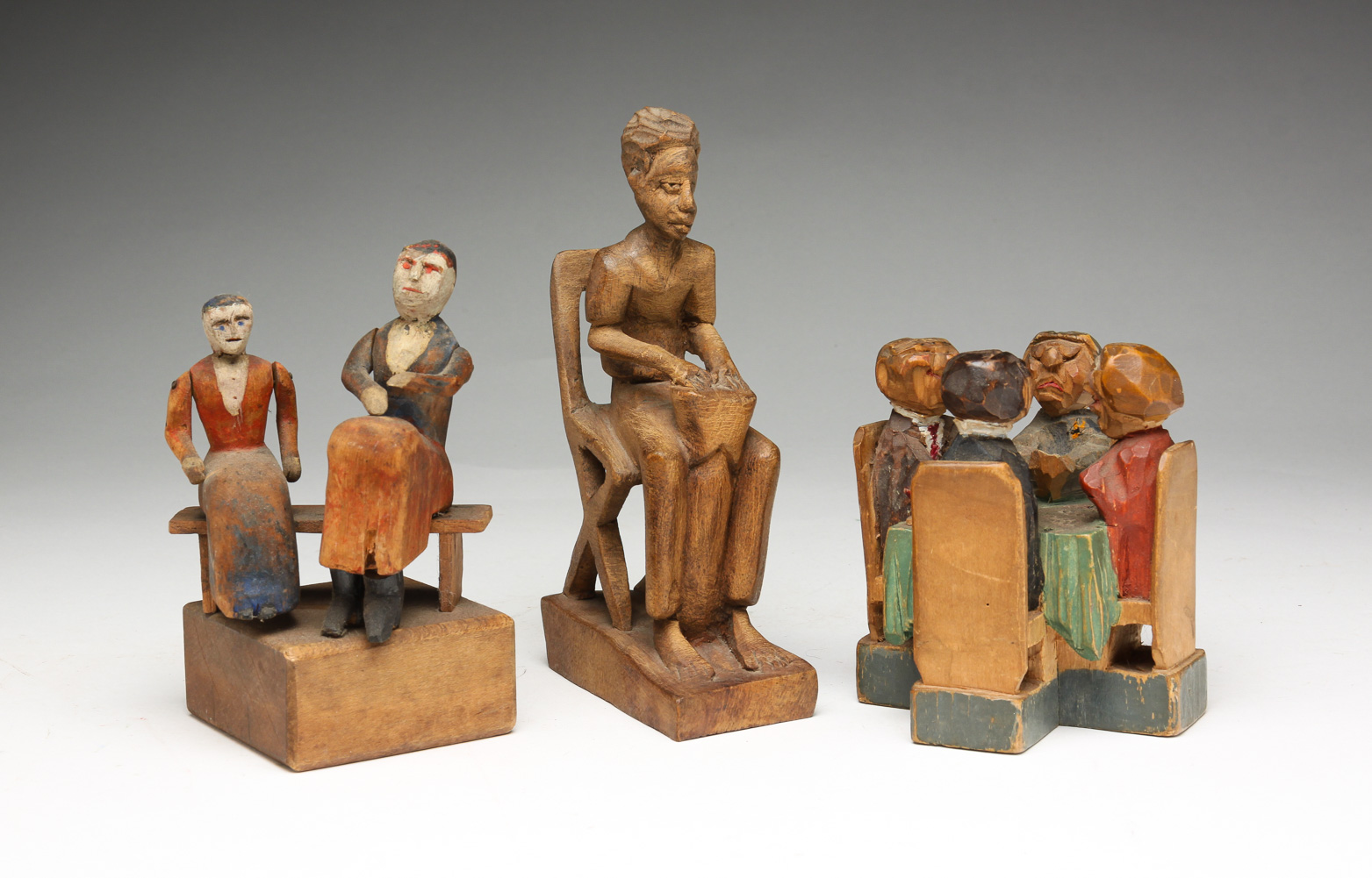 THREE FOLK ART CARVINGS OF SEATED