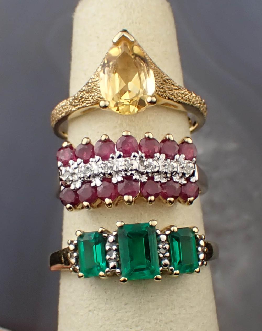 THREE GEMSTONE AND YELLOW GOLD